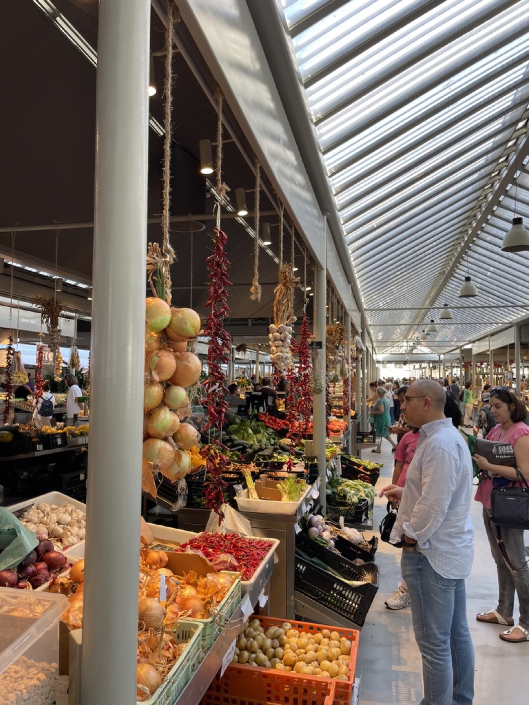 Strings of onions and dried chillies hanging over the stalls at Mercado do Bolhão